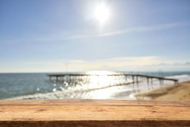 istock Empty Wooden Planks with Blur Beach on Background 1133928960