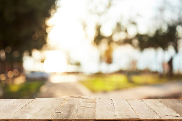 istock Wood Table Top on Blurred Tropical Background 1133928963