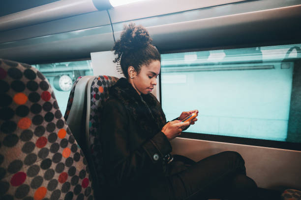 istock Girl with cellphone, suburban train 1133930479