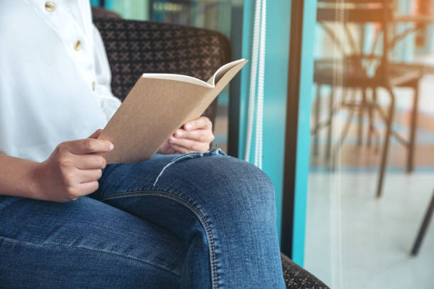 istock a woman holding and reading a book 1133931841