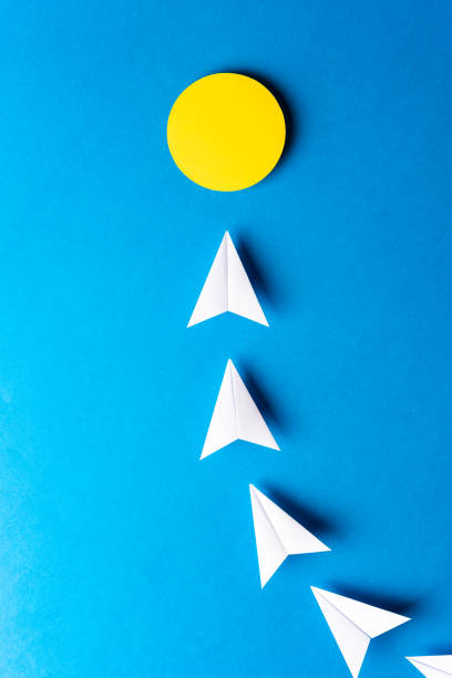 istock Idea, imagination, solution, light bulb concept. Paper white airplanes with yellow point on blue background. 1133932023