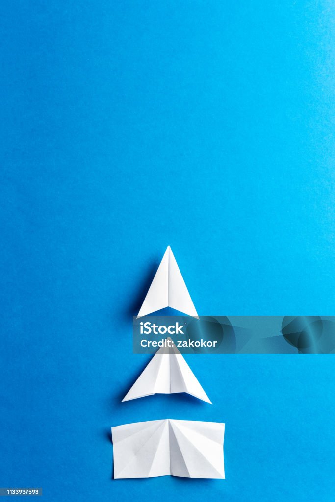 Progress concept. Development attainment, motivation, growth concept. Business concept of goals, success, achievement and challenge. White paper airplanes under construction on blue background. Concepts Stock Photo