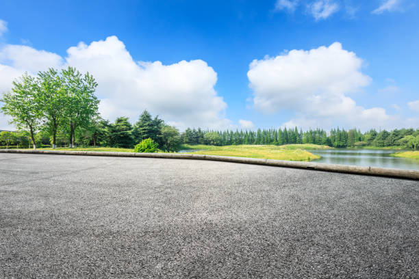 istock Empty asphalt pavement and green forest landscape in summer season 1133941680