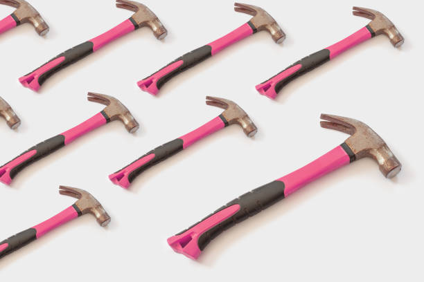 istock hammer with a pink handle on a light white background. Template for your design 1133944575