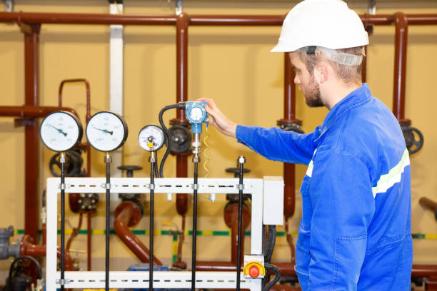 istock Technician inspector on refinery plant checking pressure gauges 1133945168