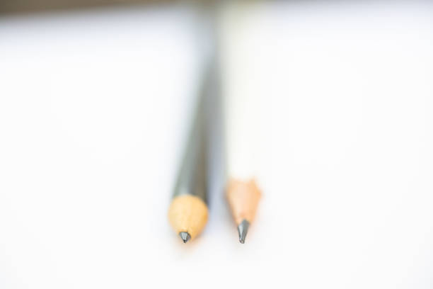 istock A white pencil with a black pencil on white background, Close up & Macro shot, Selective focus, Stationery concept 1133947222