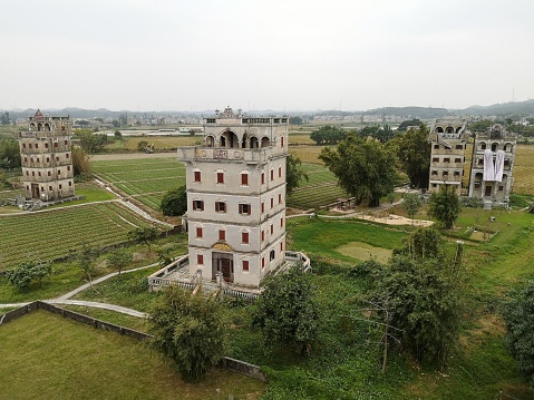 The village of Zilicun in Kaiping with the Diaolou, fortified multi-storey watchtowers that feature the fusion of Chinese and various Western architectural styles and rise up surrealistically over the rice paddy fields. Kaiping lies in Jiangmen prefecture, Guangdong province, China.
