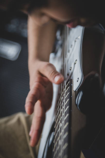 istock 8 year old British Indian boy practices the electric guitar at home. 1133952555