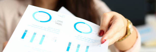 istock Female arm give financial graph papers to client 1133953620