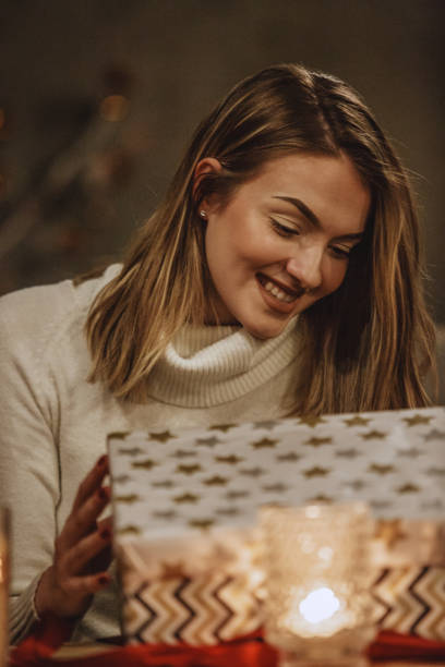 istock Happy woman opening a gift box 1133957187
