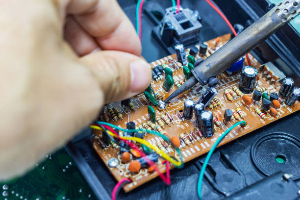 istock Technician repairing electronic of the computer circuit board by soldering Irons 1133958260