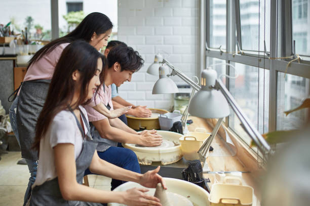 istock Female potter assisting students at pottery 1133964484