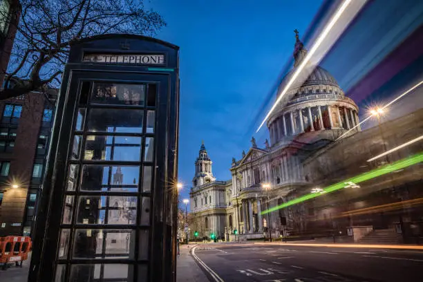 Night illuminated view of Saint Paul's Cathedral in London city with motion blur traffic (double decker bus). Shot on Canon EOS R full frame system.