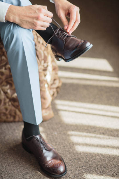 istock Grooms morning preparation, handsome groom getting dressed and preparing for the wedding 1133968883