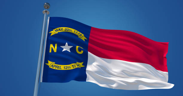 Fluttering silk flag of North Carolina, United States of America. North Carolina official flag in the wind against clear blue sky. 3d render