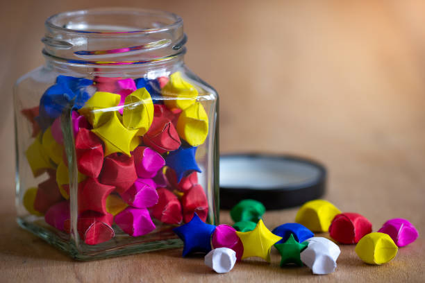 istock Multicolor paper star in square glass bottle. 1133969900