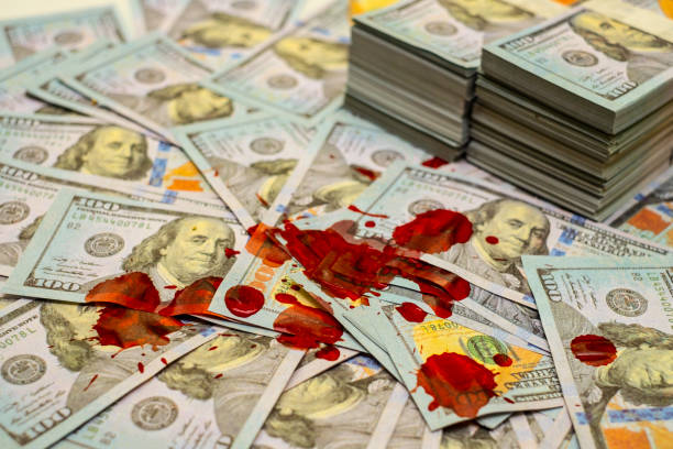 stack bundles of 100 us dollars banknotes bloody - blood bank imagens e fotografias de stock