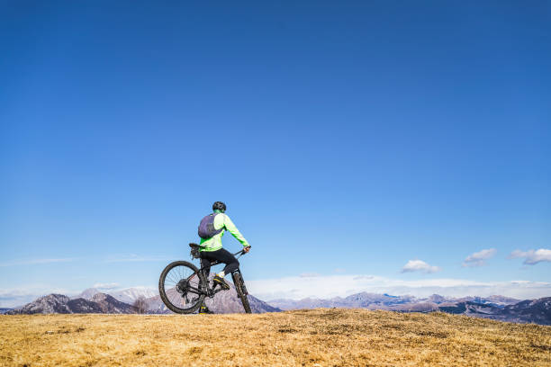 istock Mountain biker looking at mountains from over hill 1133971413