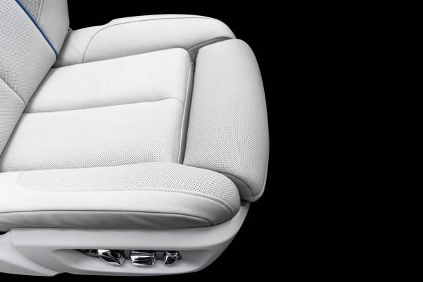istock White leather interior of a car. Perforated white leather comfortable seats with stitching isolated on black background. Car interior details. Car detailing. Car inside 1133971860