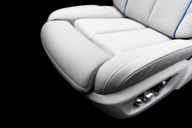 istock White leather interior of a car. Perforated white leather comfortable seats with stitching isolated on black background. Car interior details. Car detailing. Car inside 1133971870