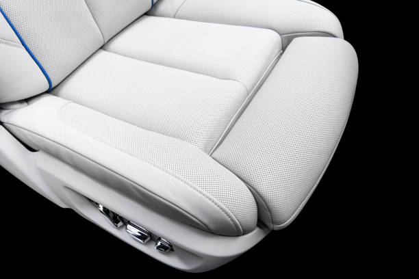 istock White leather interior of a car. Perforated white leather comfortable seats with stitching isolated on black background. Car interior details. Car detailing. Car inside 1133971908