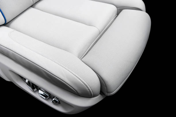 istock White leather interior of a car. Perforated white leather comfortable seats with stitching isolated on black background. Car interior details. Car detailing. Car inside 1133972782