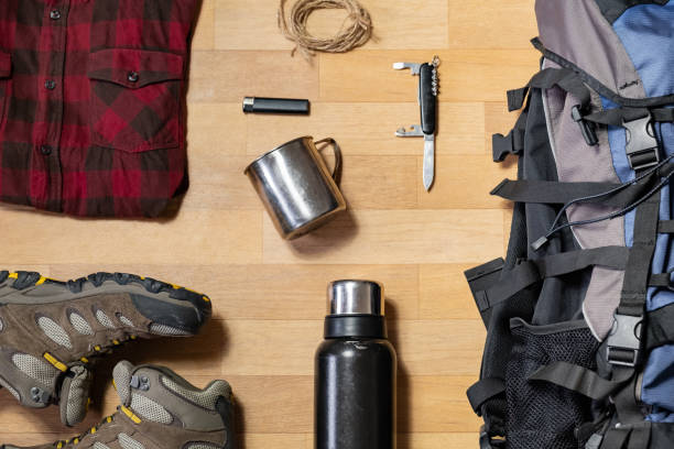 istock Preparing for a hiking trip: backpacking things and clothes flat lay. 1133972814
