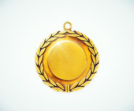 A gold medal surrounded by a laurel leaf motif but blank for your name, achievement, or sport to be added, on a white background.