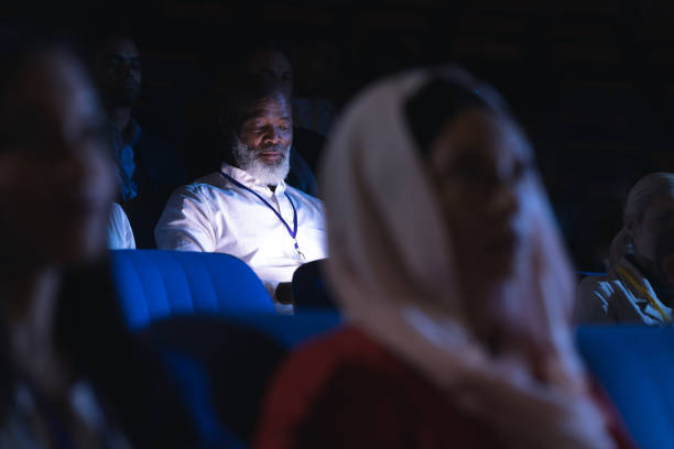 istock Businessman looking at digital tablet while sitting in the auditorium 1133973333