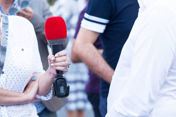 istock Female reporter making press or media interview 1133973434