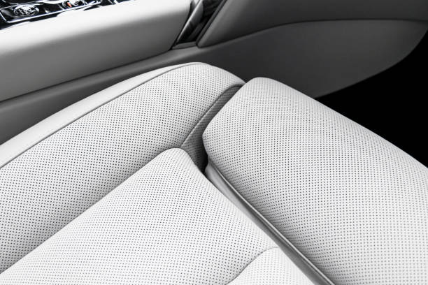 istock White leather interior of a car. Perforated white leather comfortable seats with stitching isolated on black background. Car interior details. Car detailing. Car inside 1133973446