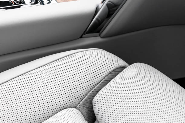 istock White leather interior of a car. Perforated white leather comfortable seats with stitching isolated on black background. Car interior details. Car detailing. Car inside 1133973452