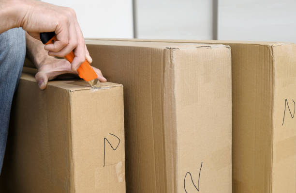 istock A man is unpacking the cardboard boxes. 1133975723