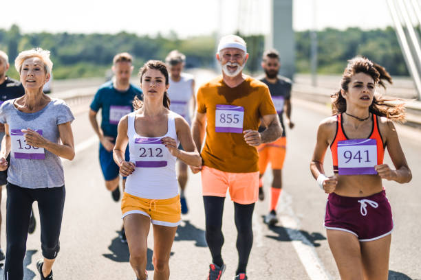 istock Large group of mix-aged marathon runners on a bridge. 1133978517