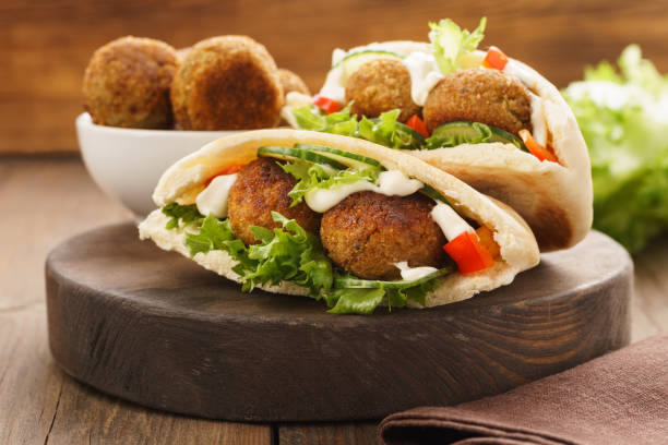 istock Falafel and fresh vegetables in pita bread with sauce. 1133978840