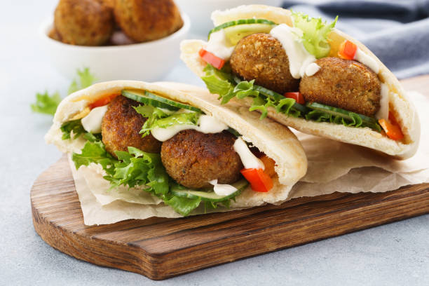 istock Pita breads with falafel, fresh vegetables and sauce. 1133980187