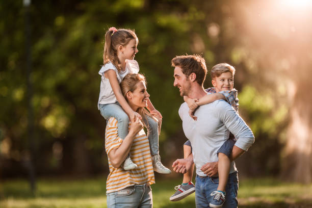 istock Young parents having fun with their kids in the park. 1133980202