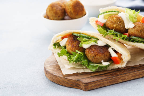 istock Pita breads with falafel, fresh vegetables and sauce. 1133980659