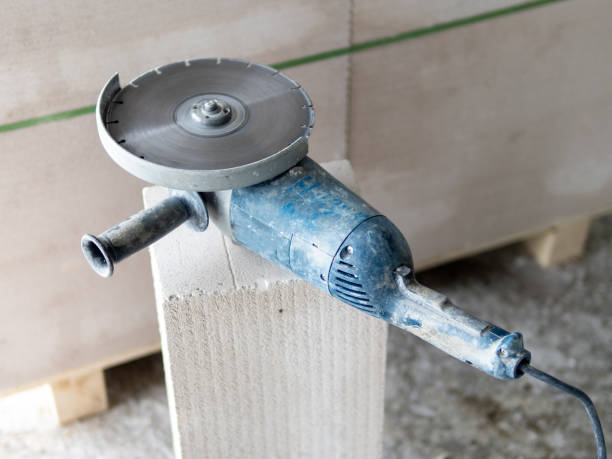 istock Angle grinder with disc for concrete on the grey brick. 1133981113
