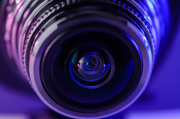 istock Camera lens with violet-blue illumination. Horizontal photo. 1133983595
