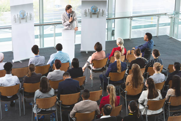 istock Male speaker with microphone speaks in a business seminar 1133985653