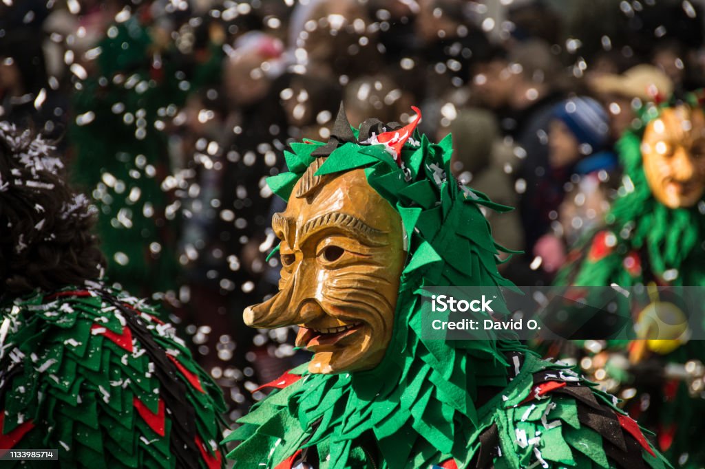 Participant of Rosenmontag(Shrove Monday) parade at Freiburg im Breisgau in front od Confetti The annual Rosenmontagsparade in Freiburg gerrmany, is one of the highlights ofthe regional carnival. Many participants wear traditional costumes and masks Carnival - Celebration Event Stock Photo