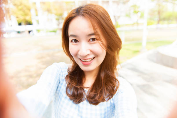 istock young woman smile take selfie 1133987531
