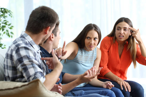 istock Two men and women arguing at home 1133988079