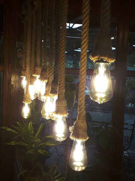 istock Cold-electric bulbs on a knitted string in retro style like luminaries 1133988180