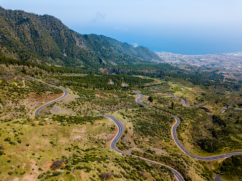 Aerial view of Mountain pass road in Tenerife, Santa Cruz de Tenerife City and Atlantic ocean in the background, Canary island.