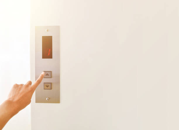 istock Businessman hand press open button to extend office building elevator doors 1133990999