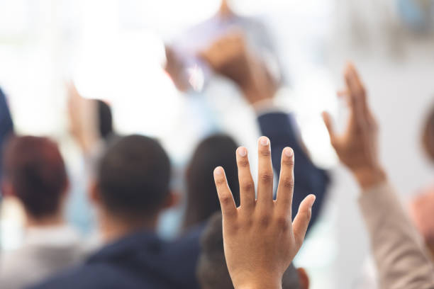 istock Hands raised in a business seminar 1133991053