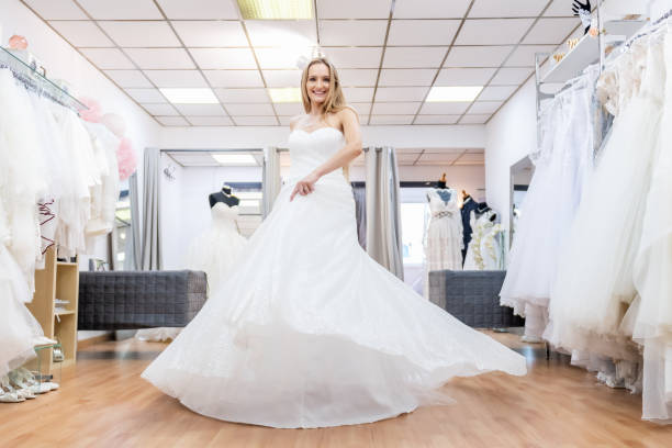 istock Woman/bride dancing in bridal shop 1133991409