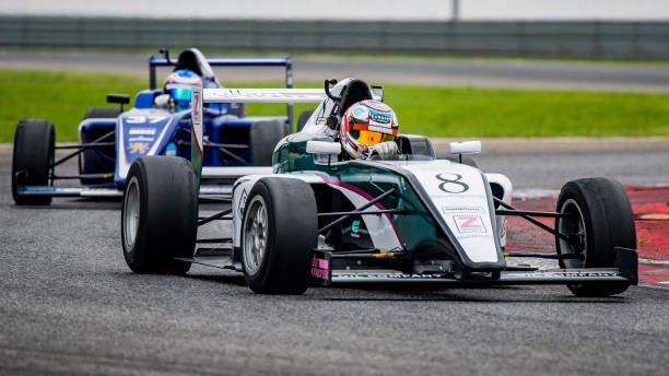 istock Men driving racing cars 1133992330